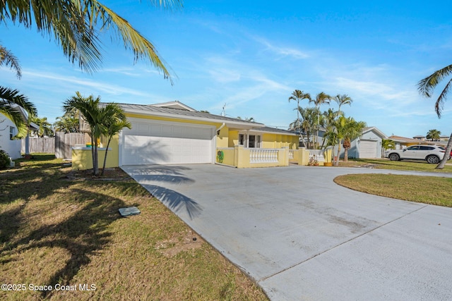 ranch-style home with stucco siding, concrete driveway, an attached garage, a front yard, and fence