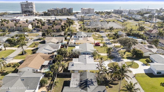 drone / aerial view featuring a water view and a residential view