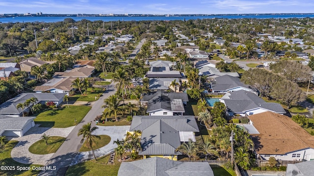 birds eye view of property with a water view and a residential view