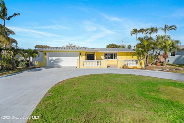 single story home featuring stucco siding, concrete driveway, a standing seam roof, metal roof, and a garage