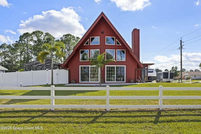 view of side of property with a lawn