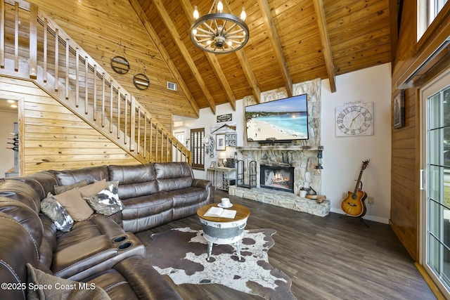 unfurnished living room with hardwood / wood-style floors, wooden ceiling, high vaulted ceiling, a fireplace, and beamed ceiling