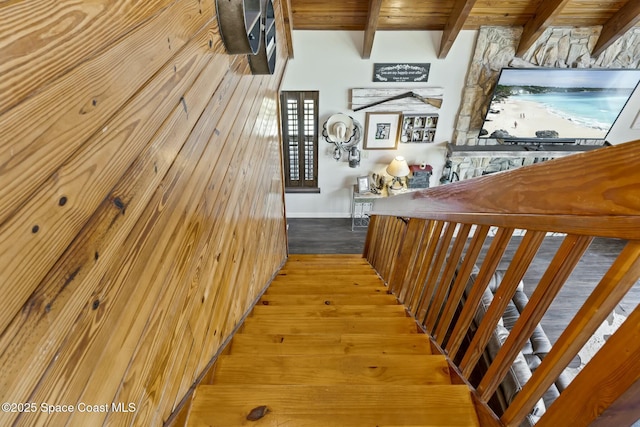 stairway featuring hardwood / wood-style floors, beam ceiling, and wood ceiling