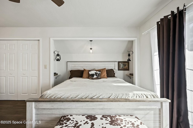 bedroom featuring ceiling fan, dark hardwood / wood-style flooring, and a closet