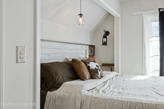 bedroom with lofted ceiling