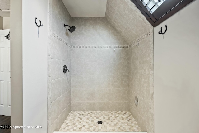 bathroom with a tile shower