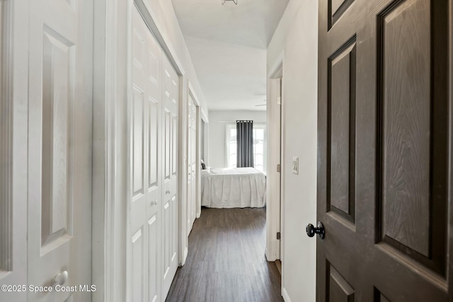 hallway with dark hardwood / wood-style flooring