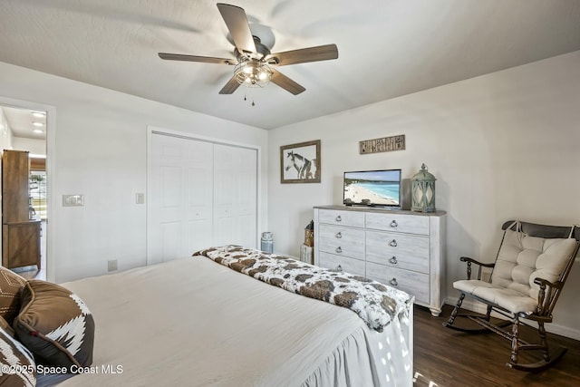 bedroom with ceiling fan, dark hardwood / wood-style floors, and a closet