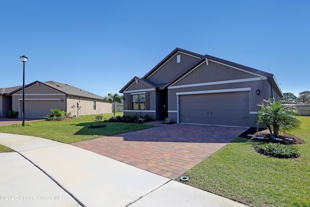 ranch-style home featuring a front lawn and a garage