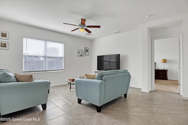 tiled living room featuring ceiling fan