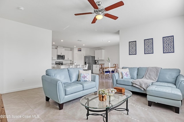 tiled living room featuring ceiling fan