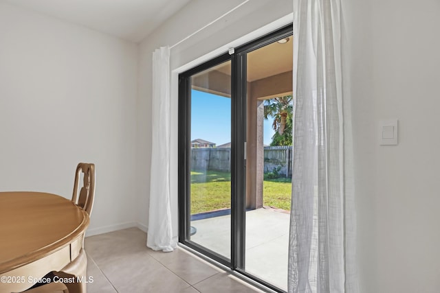 doorway to outside with tile patterned flooring