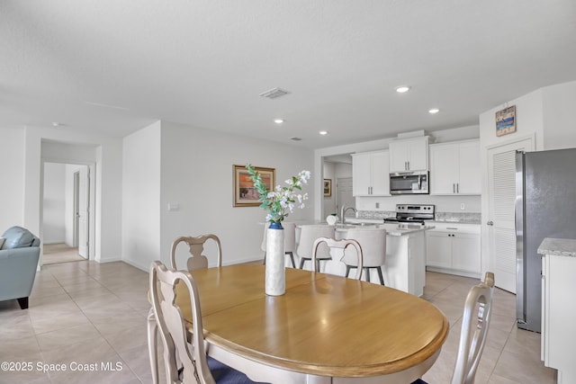 tiled dining area featuring sink