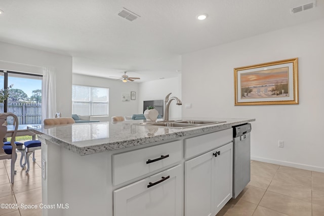 kitchen with sink, white cabinets, dishwasher, ceiling fan, and a center island with sink