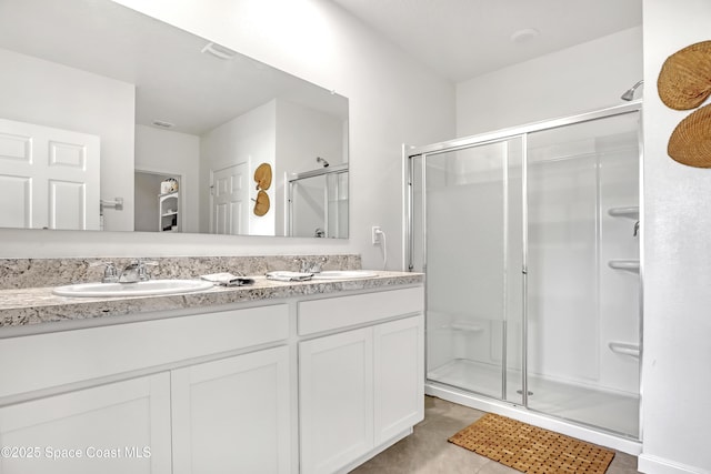 bathroom featuring tile patterned floors, walk in shower, and vanity