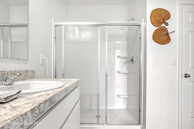 bathroom with walk in shower and vanity