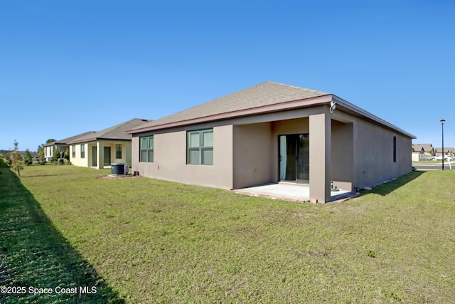 back of property with a patio area and a lawn