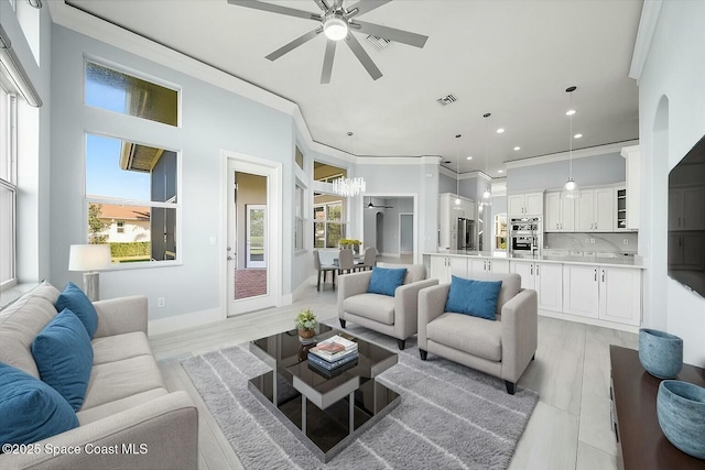 living room with crown molding, ceiling fan, and light hardwood / wood-style flooring