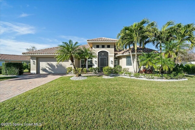 mediterranean / spanish-style house with a garage and a front yard