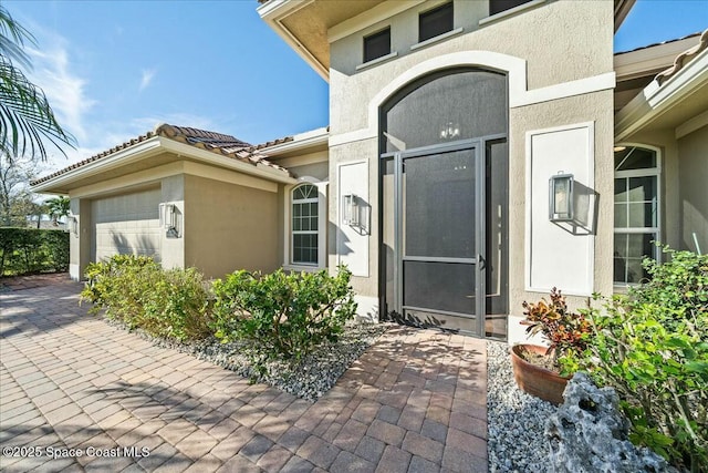 view of exterior entry with a garage