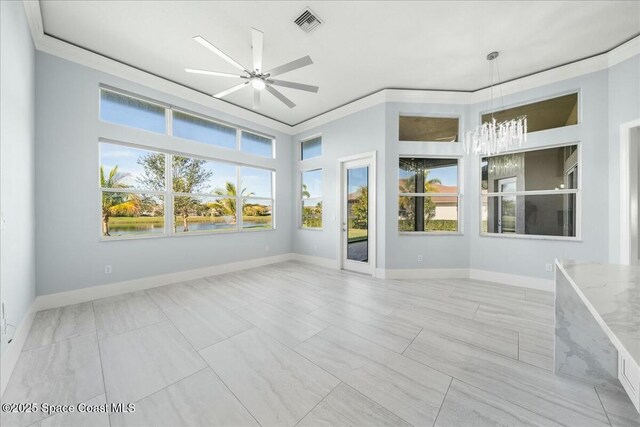 unfurnished sunroom featuring ceiling fan with notable chandelier