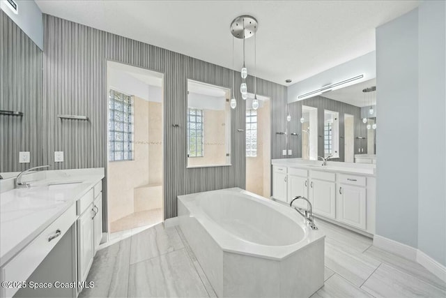 bathroom with vanity and a bath