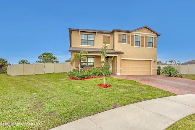 view of front facade featuring decorative driveway, fence, and stucco siding