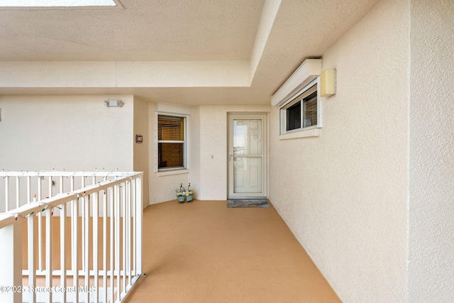 view of exterior entry featuring a balcony