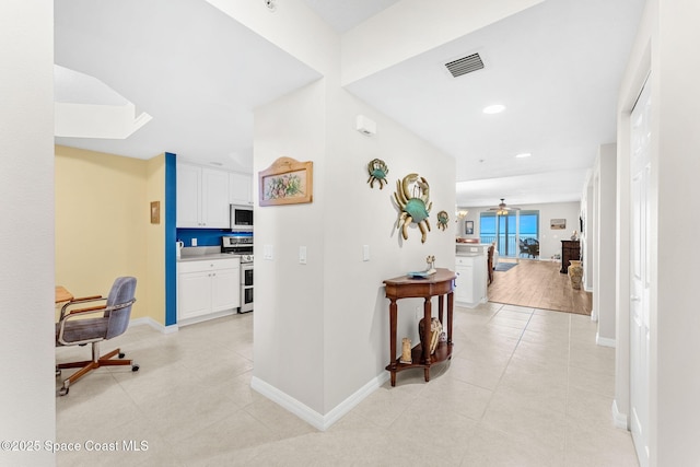 hallway featuring light tile patterned floors