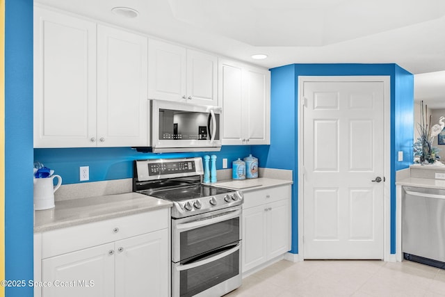 kitchen with stainless steel appliances and white cabinetry