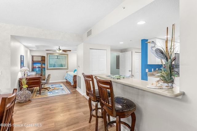 dining space featuring ceiling fan and wood-type flooring