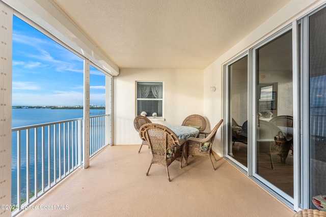 balcony featuring a water view