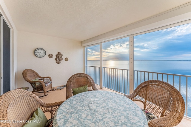 sunroom / solarium with a water view