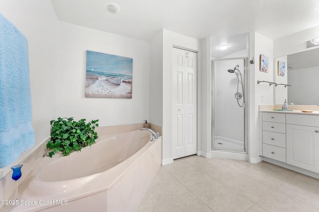 bathroom featuring tile patterned flooring, plus walk in shower, a textured ceiling, and vanity