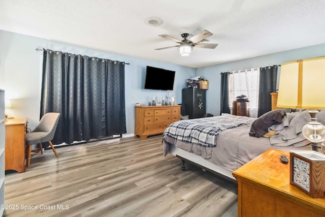 bedroom with ceiling fan and hardwood / wood-style flooring