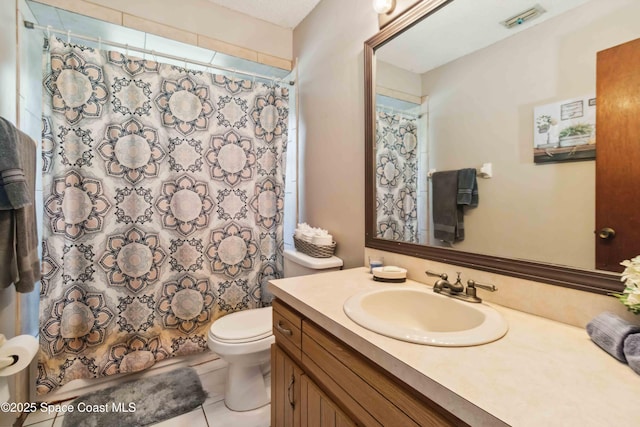 bathroom featuring toilet, a shower with shower curtain, tile patterned flooring, and vanity