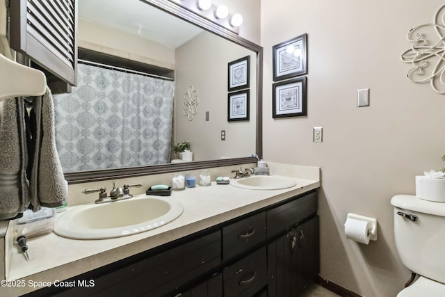 bathroom featuring toilet and vanity