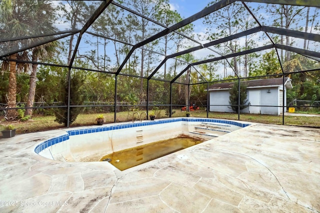 view of swimming pool with a lanai, a patio area, and a storage unit