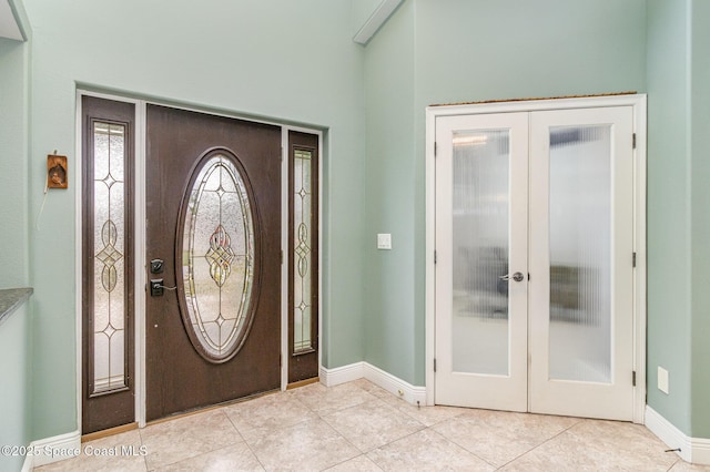 foyer entrance with french doors and light tile patterned floors