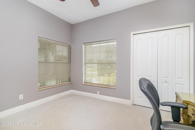 home office featuring ceiling fan and light colored carpet