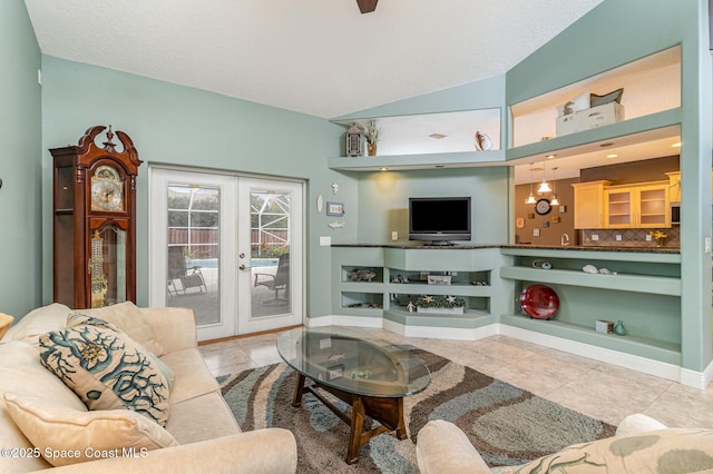 tiled living room featuring french doors, vaulted ceiling, and built in features