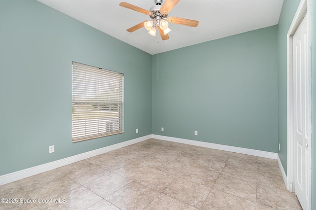 unfurnished room with ceiling fan and light tile patterned floors