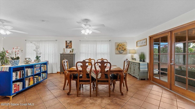 dining space with ceiling fan, light tile patterned floors, a healthy amount of sunlight, and french doors