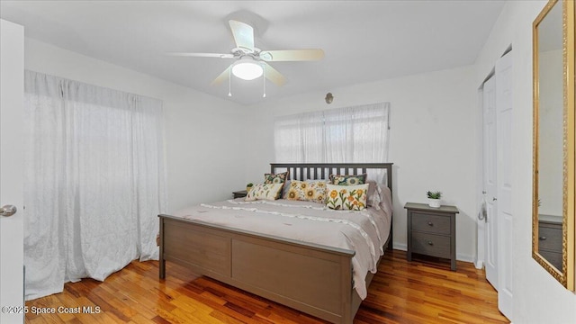 bedroom featuring ceiling fan, hardwood / wood-style flooring, and a closet