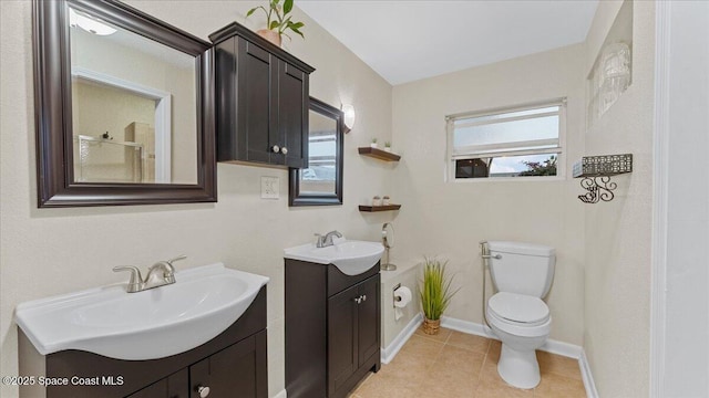 bathroom with toilet, vanity, and tile patterned flooring