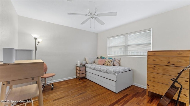 bedroom with ceiling fan and dark hardwood / wood-style flooring