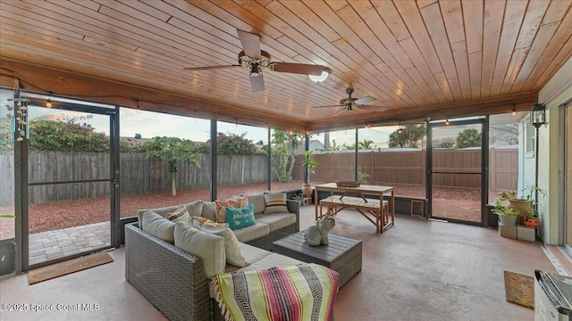 sunroom featuring ceiling fan, plenty of natural light, and wood ceiling