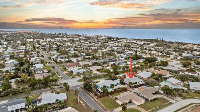 aerial view at dusk with a water view