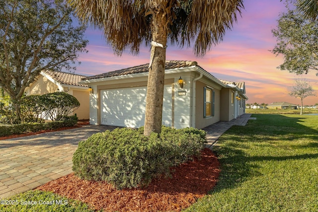 view of front of property featuring a lawn and a garage