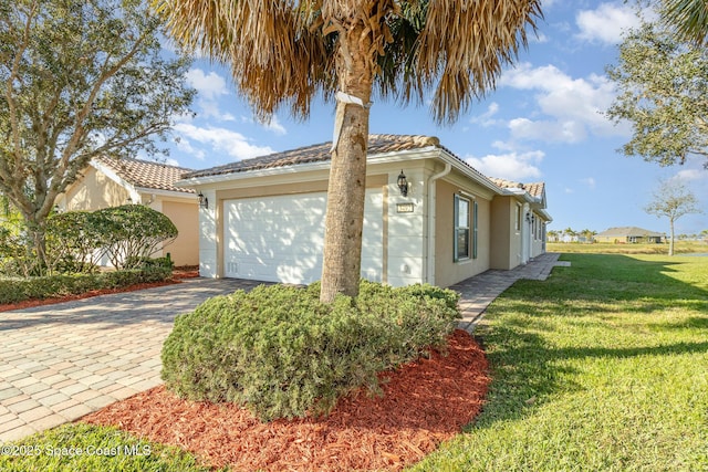 view of side of home featuring a yard and a garage